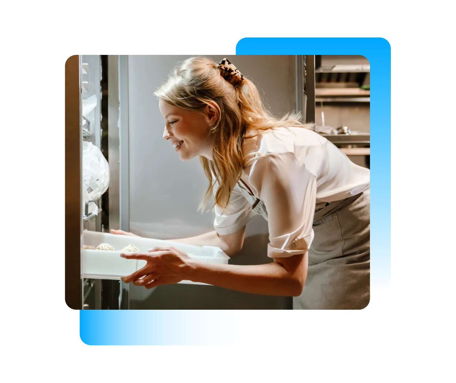 A kitchen worker at an open fridge, with ColdAssure monitoring cards showing fridge and freezer temperature, door state and a breach alert